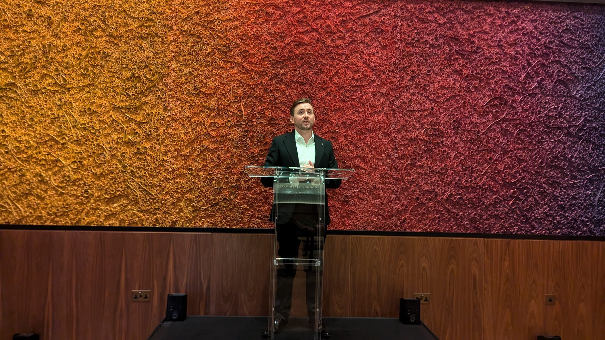 Kevin Durham at the lectern hosting a hotel opening