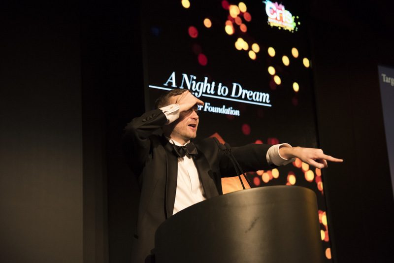 Kevin Durham at the lectern hosting an awards gala