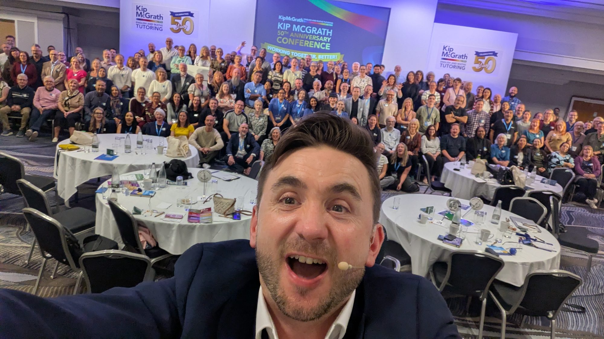 Kevin Durham with a full conference room of delegates behind him at the end of a two-day conference