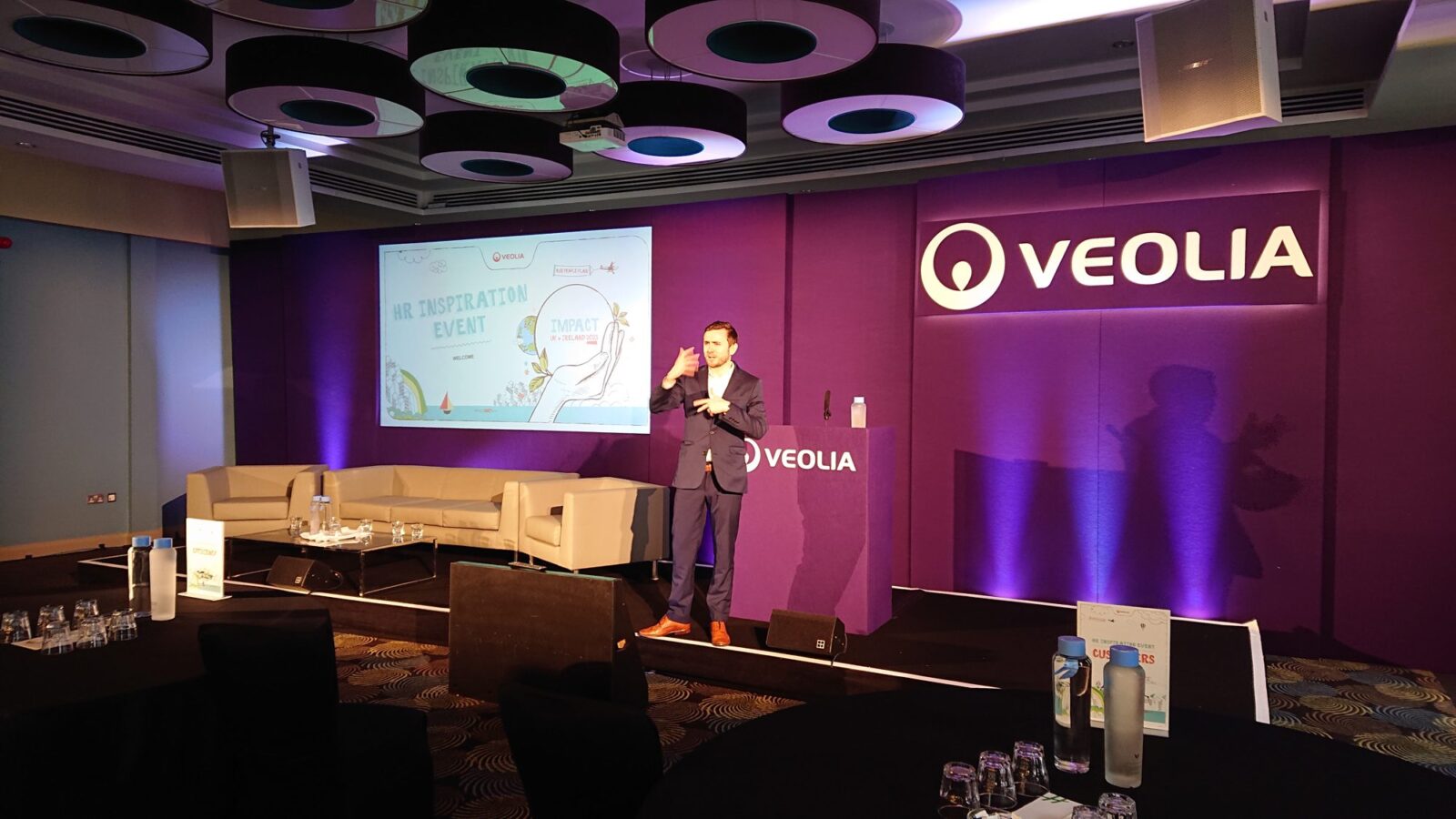 Kevin Durham hosting the Veolia conference from a wide stage